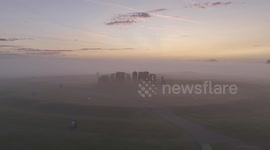 drone footage of Stonehenge sunrise in mist