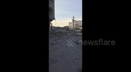 Palestinians inspect the devastation left behind an Israeli airstrike on the Al Jalaa Street