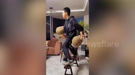 Boy shows off basketball dribbling skills while perched on bench