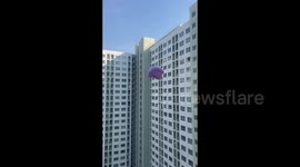 Bed sheet escapes from condo room and flies through the air