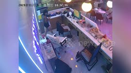 Receptionist topples backwards while trying to climb onto chair