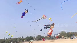 Hundreds of colourful cartoon-shaped kites fly at a festival in India