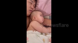 Father's loud snoring startles baby lying next to him