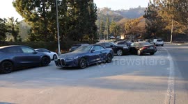 Residents escaping L.A. wildfire left their cars behind to flee on foot.