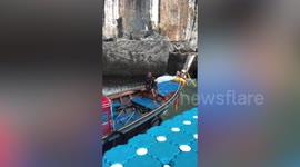 Tourists cling onto boats while being rocked by huge swells in Thailand