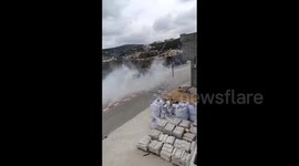 Israeli forces fire tear gas canisters during their raid of the town of Beita, south of Nablus