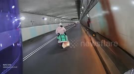 Delivery rider's food box tumbles from the back of bike
