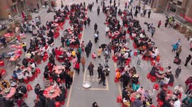 China: Community Owners Sit Around Tables and Eat Soup