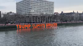Climate activists dropped a giant anti-Donald Trump banner opposite the Houses of Parliament in central London