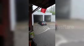 Car swept away in Indonesia floods, locals assist in evacuation