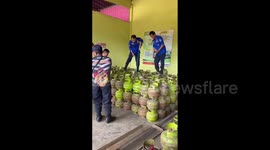 Huge python found hiding among gas cylinders in shop