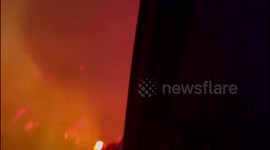 Helicopter surveys Palisades Fire with flames just semi-contained