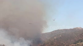 Planes dump retardant on smoldering Palisades Fire in California