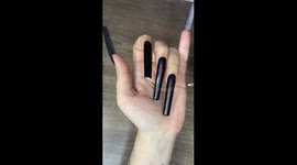 Elegant manicure: metallic graffiti and rhinestones on a black base. The video shows the step-by-step process of creating a stylish manicure using black polish, metallic patterns and rhinestones. The black glossy base serves as a backdrop for an elegant d