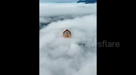 Drone Captures Stunning Footage of Buddha Statue Emerging from Cloud Waterfall in China