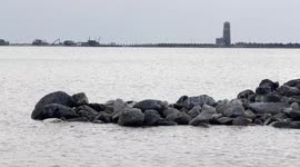 The stretch of sea where Royal Caribbean plans to build the first large privately managed tourist port in Italy and in the background the old lighthouse of Fiumicino, near Rome.