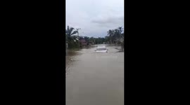 Car drives through flooded road amid heavy rain in Indonesia