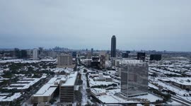 Drone shot of a January 21, 2025 Houston winter snow storm consequences from Galleria area, with a view on Williams tower and Downtown in the background