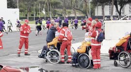 Red Cross volunteers care for people with disabilities during the ‘Corsa di Miguel’ in Rome.