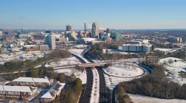 A 4K drone flight over downtown Raleigh, North Carolina after a rare snowfall blankets the region.