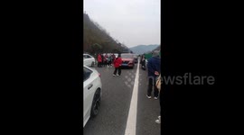 Woman Dances on Highway to Pass Time During Traffic Jam