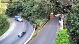 Lorry loaded with maize overturns on sharp bend and crushes oncoming car