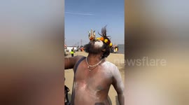 Naked sword swallower impresses visitors to bathing festival in India