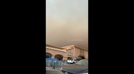 Brown haze from Hughes Fire looms over Walmart in California