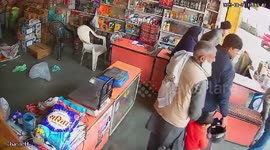 Stray bulls fighting in street tumble into shop in India