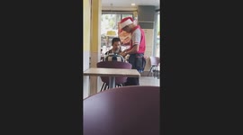Kind fast food waiter helps disabled customer to eat spaghetti