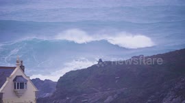 30 foot waves lash West Britain, Storm Eowyn, spectators dwarfed by ocean breakers, Fistral Bay, Cornwall, UK