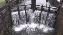 Storm Eowyn on the forth and clyde canal with fallen tree and  lock waterfall spray