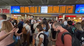 Travelers stopped at the Rome Termini station waiting to be able to catch a train while the boards signal severe delays in train departures and arrivals due to a technical fault at the Termini and Tiburtina railway stations in Rome.