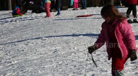 Kids and adults have fun sledding and tubing  down a hill after a rare snowstorm hits Southeast North Carolina, USA