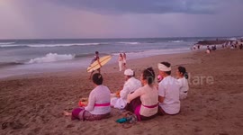 Balinese pray during bad weather at Canggu beach, Bali, Indonesia