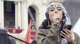 Maya Issa, leader of the Palestinian Student Movement in Italy, speaks to protesters during the demonstration in support of the Palestinian people organized close to Remembrance Day by various Palestinian associations in Rome.