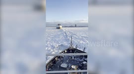 U.S. Coast Guard vessel breaking ice to free Canadian ship stuck in frozen Lake Erie