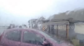 Storm chaser jumps into rescue trying to evacuate two dogs in a wrecked car from violent 80+mph winds in Cornwall during Storm Herminia