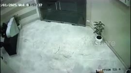 Furious resident smashes glass entrance door to wake sleeping security guard