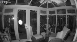 A ring camera captures two moving orbs of lights in the conservatory or this unattended house
