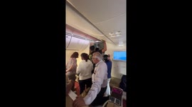 Furious 'suffocating' passengers bang on plane doors after 'five hour delay without air con'