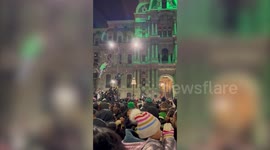 Eagles fans climb trees and vehicles during celebrations in Philadelphia