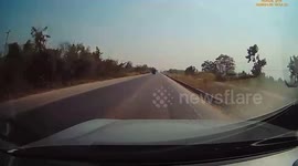 Passenger sitting on pickup truck falls from the back onto road