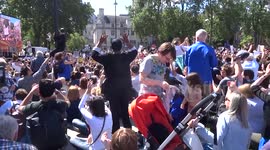 March for Europe participants sit down and clap their hands at the end of anti-Brexit protest next to Parliament