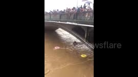 Police officer swept away by floods saved after being dragged down river