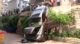 Luxury car crashes down retaining wall in residential area