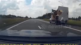 Lorry side panel smashes onto car