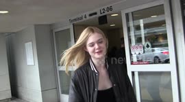 Actress Elle Fanning , younger sister of Dakota Fanning graciously signs autographs, poses for fans and answers paparazzi questions as she arrives at LAX Airport in Los Angeles, Ca