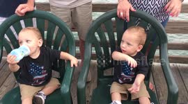 Twin babies dance to pop music on fishing pier