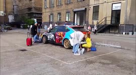 Car getting Graffiti on it as part of the Free Range student art fair in Brick Lane